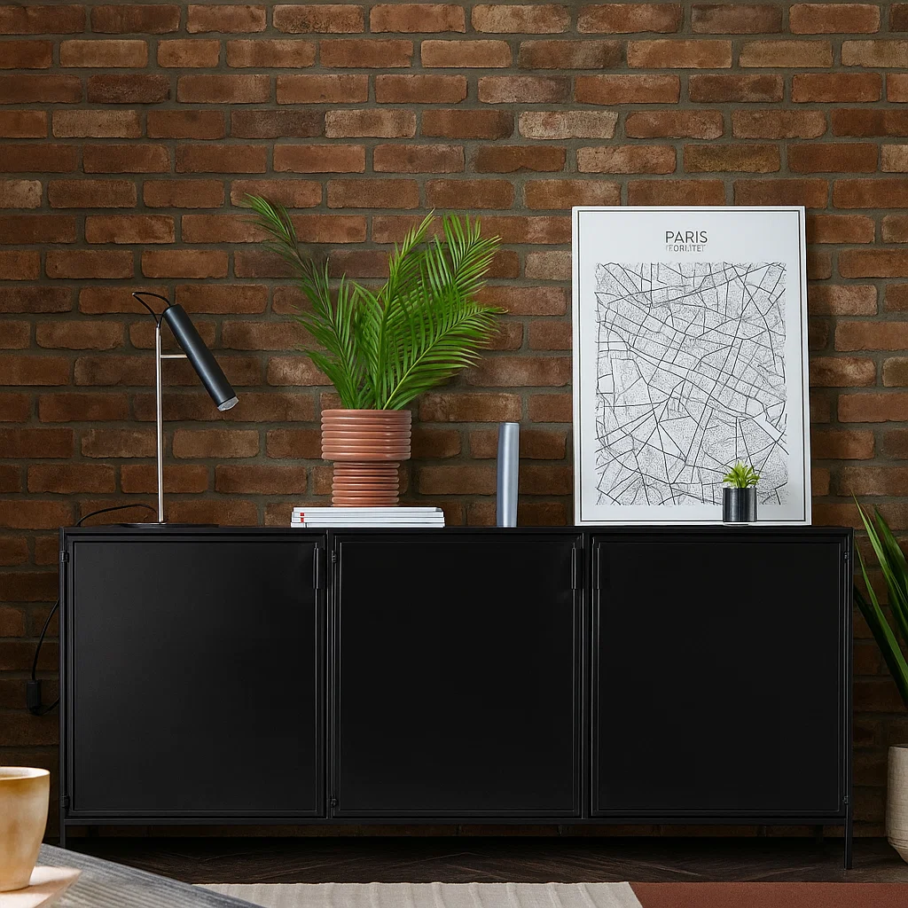 Sleek black metal sideboard against exposed brick wall with decor items