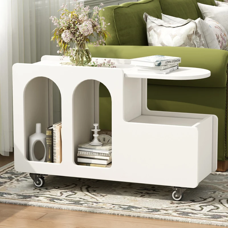 White rolling end table with open shelves and flower vase near sofa