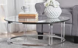 Glass round coffee table with books and vase in living room