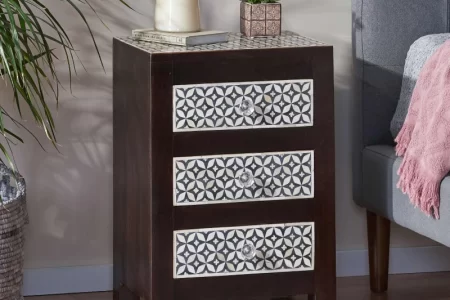 Dark wood 3-drawer nightstand with patterned front panels beside bed