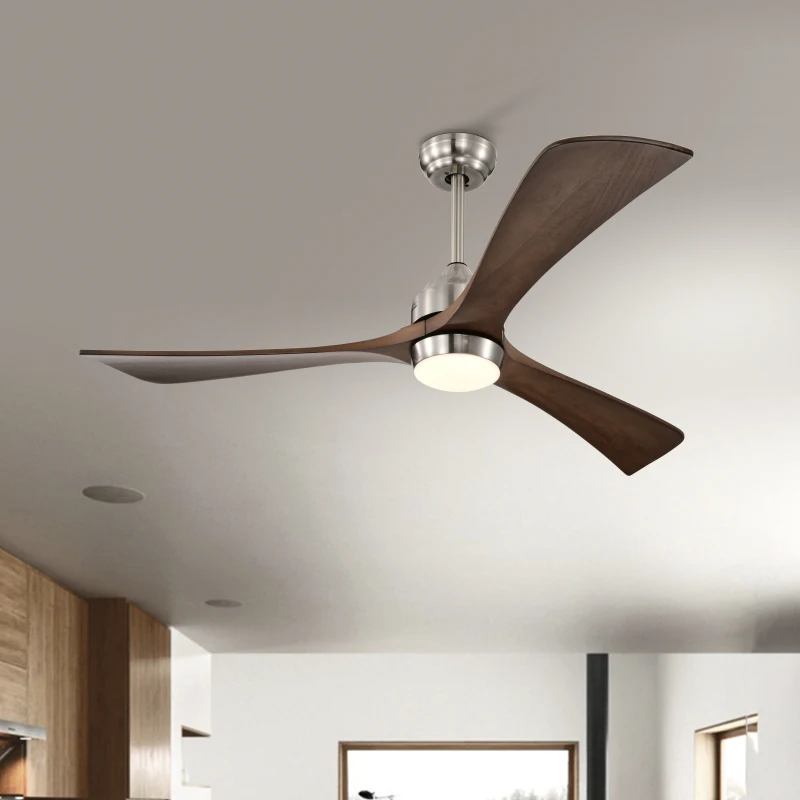 Wood-blade ceiling fan with brushed metal finish providing LED lighting above a modern dining area with pool view.
