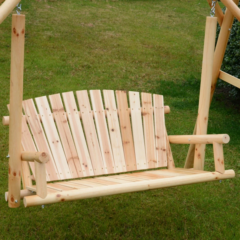 Natural cedar wood swing bench hanging outdoors on lawn.