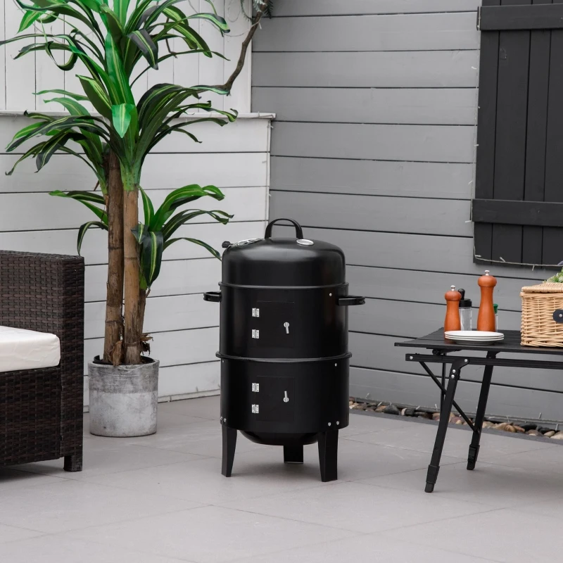 Black vertical charcoal smoker grill on modern patio corner.