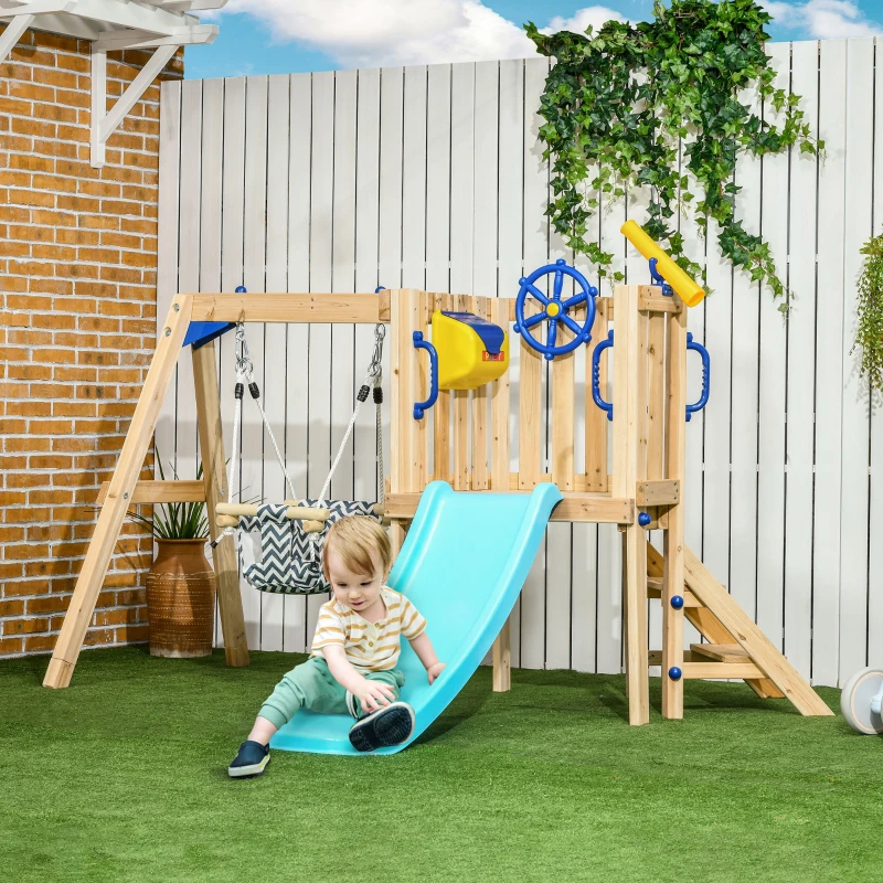 Toddler on blue slide of wooden backyard playset.