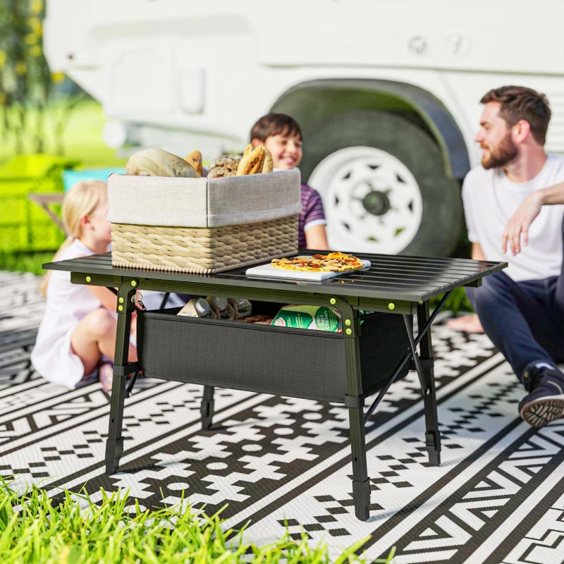 Family enjoying camping with adjustable-height folding table.