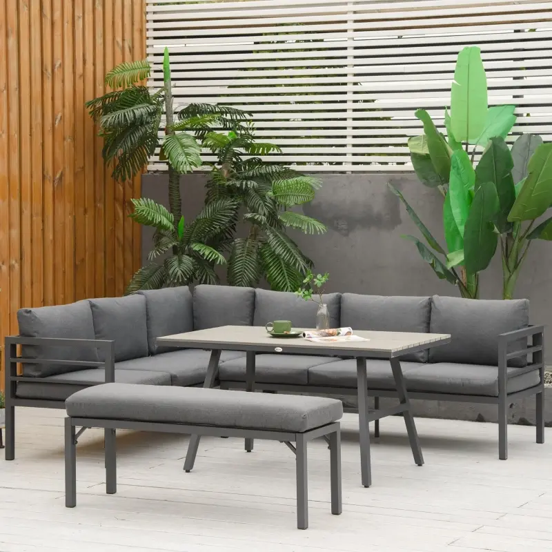Grey cushioned sectional outdoor set with matching bench and table.