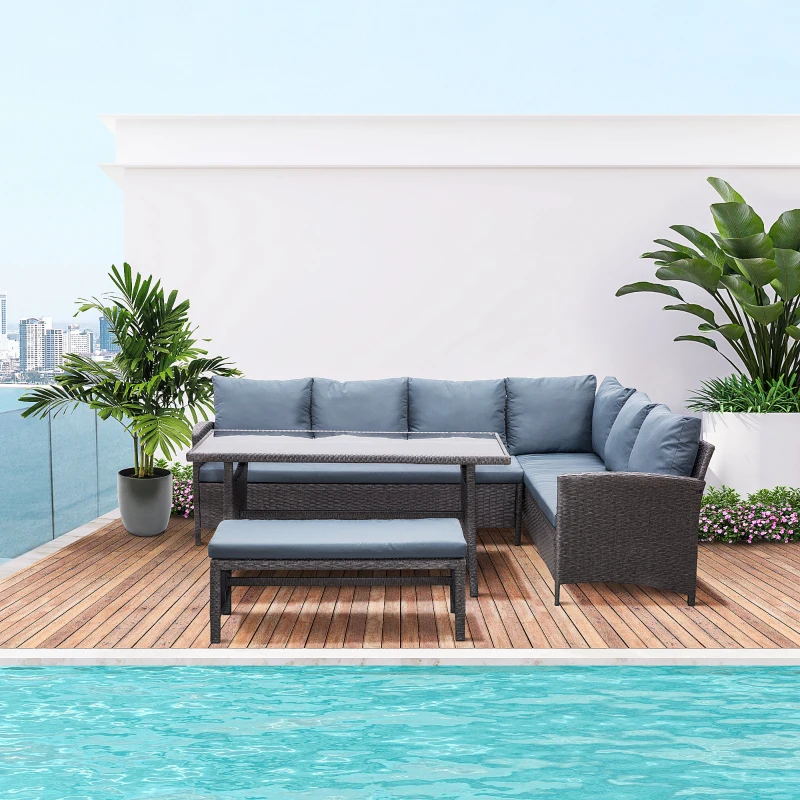Grey rattan sectional sofa set with table beside pool.