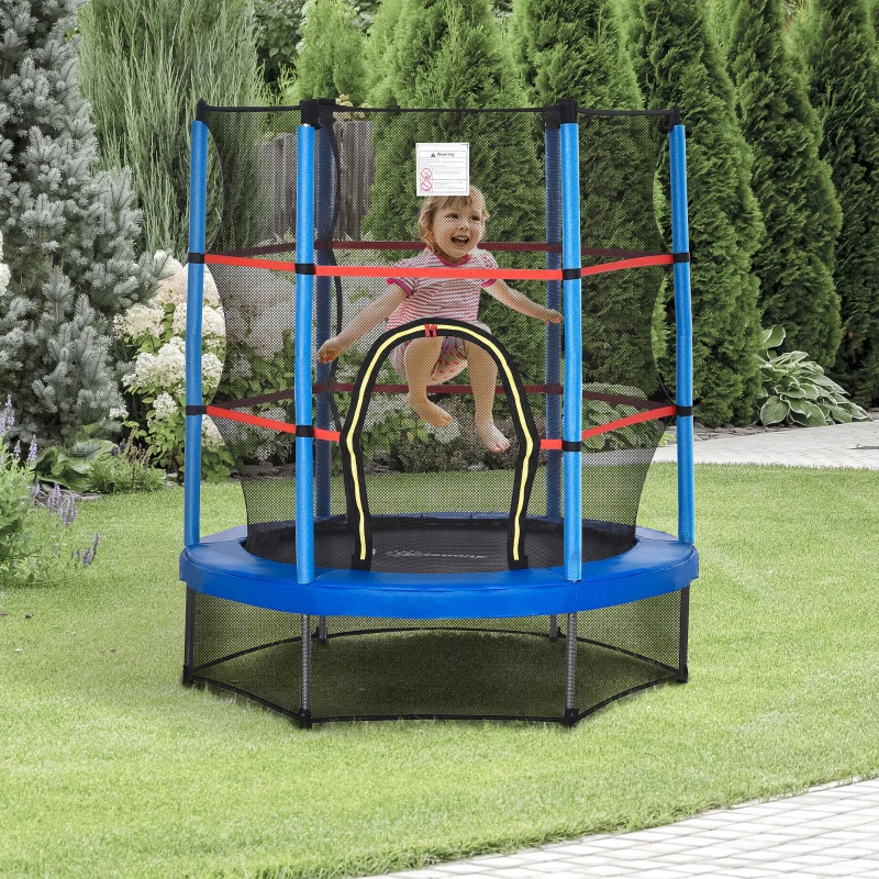 Smiling child jumping on blue trampoline with safety net in garden.