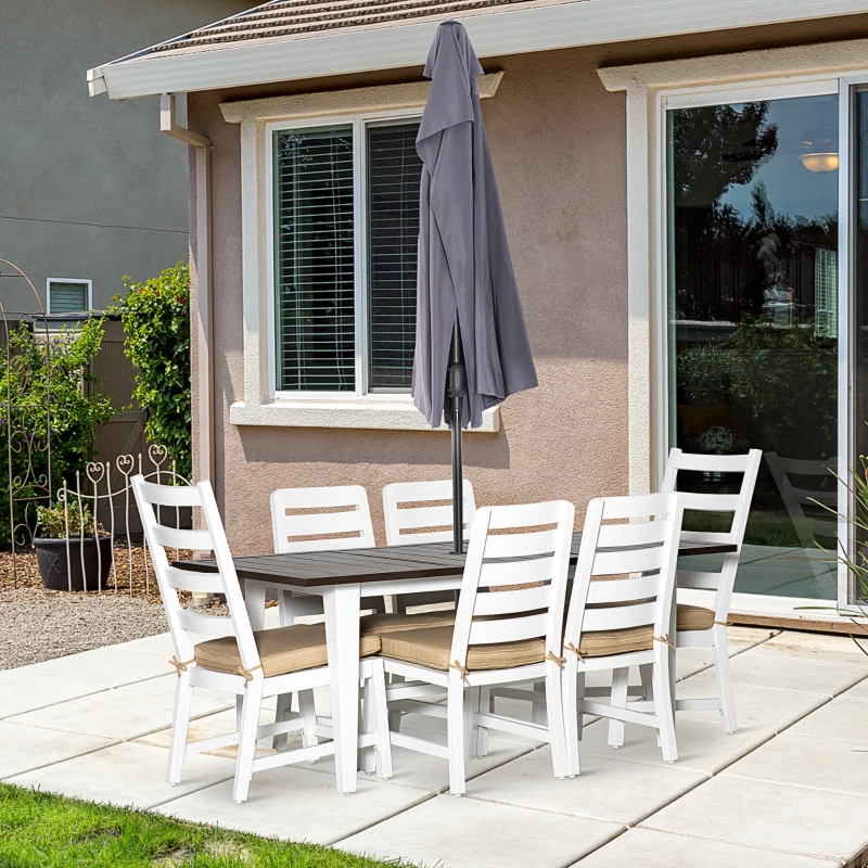 Modern white patio dining set with umbrella on tiled patio.
