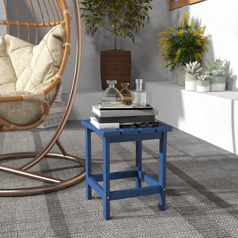 Blue outdoor end table with books and glassware on patio
