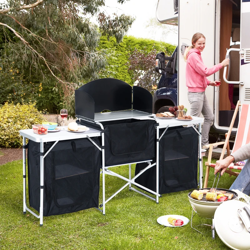 Outdoor kitchen station with windscreen for cooking.