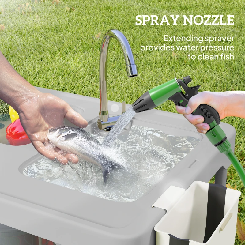 Fish cleaning table with built-in sinks and faucet outdoors.