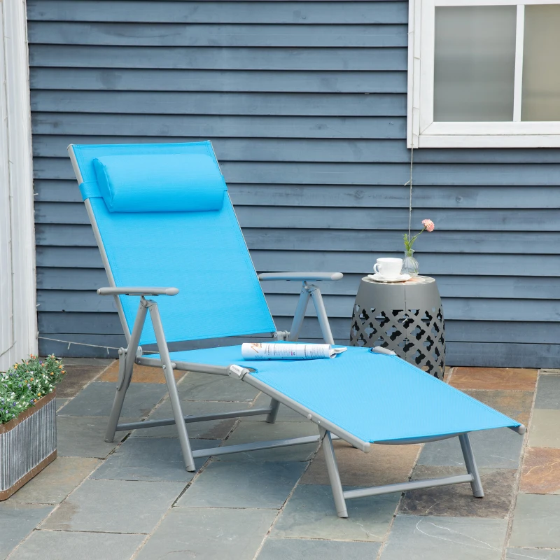 Blue adjustable lounge chair on patio with drink and magazine