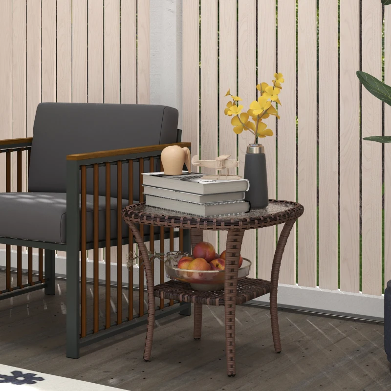 Outdoor wicker round side table with books and fruit bowl on patio.