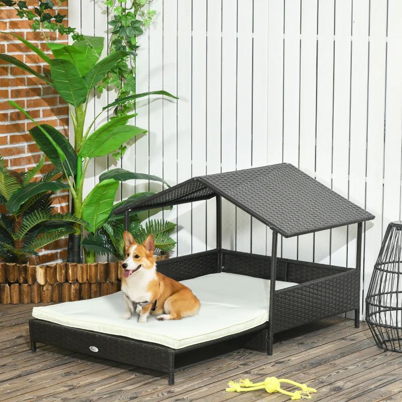 Corgi sitting on outdoor wicker dog bed with canopy
