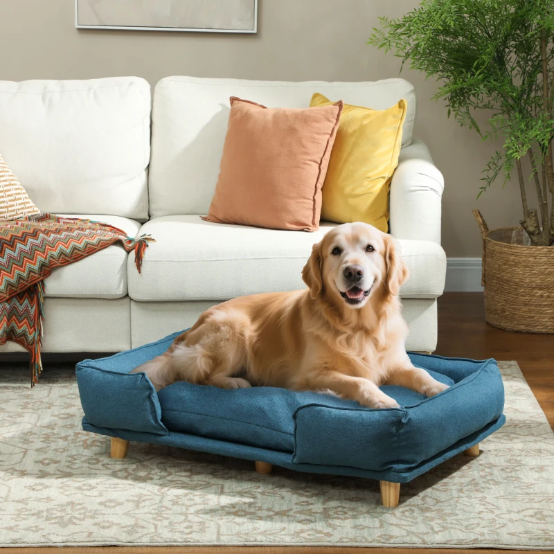 Golden retriever relaxing on blue raised cushion dog bed

