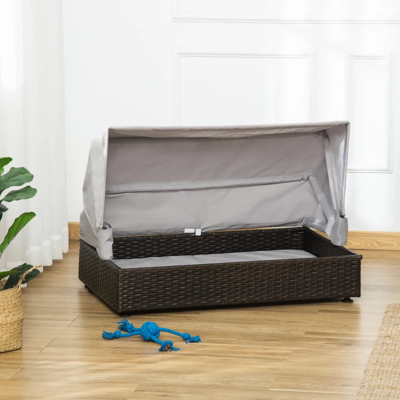 Empty wicker dog bed indoors with foldable gray canopy
