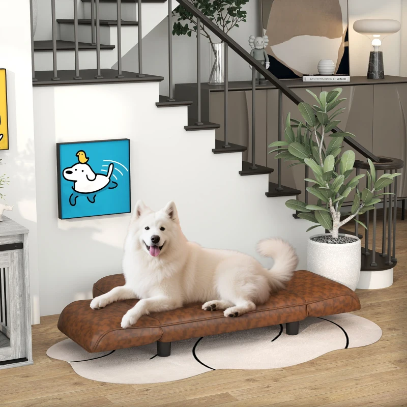 White fluffy dog resting on brown leather sofa dog bed
