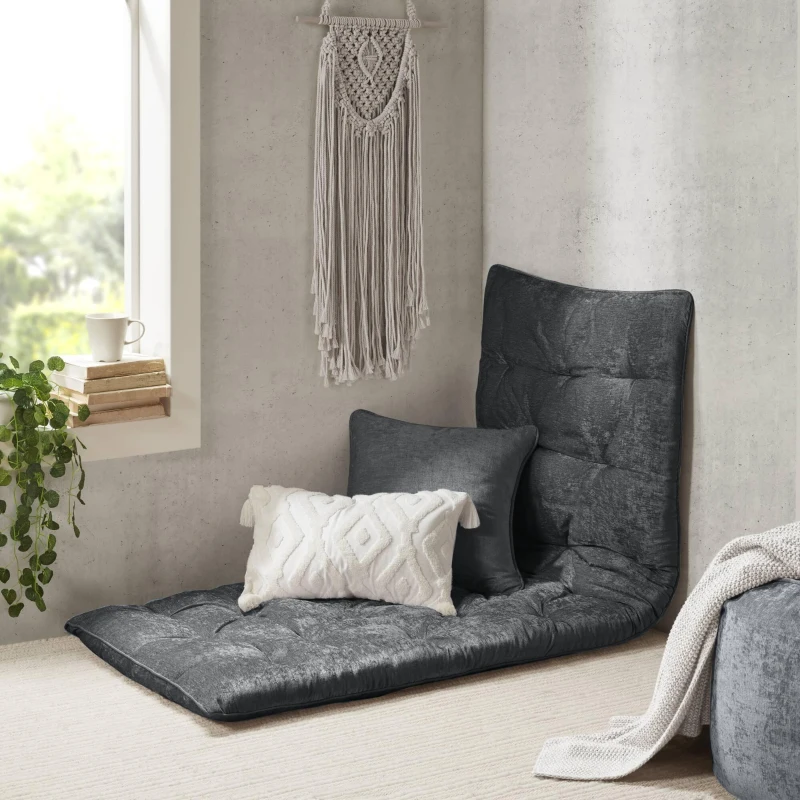 Gray floor lounge cushion with matching pillows in a cozy reading corner.