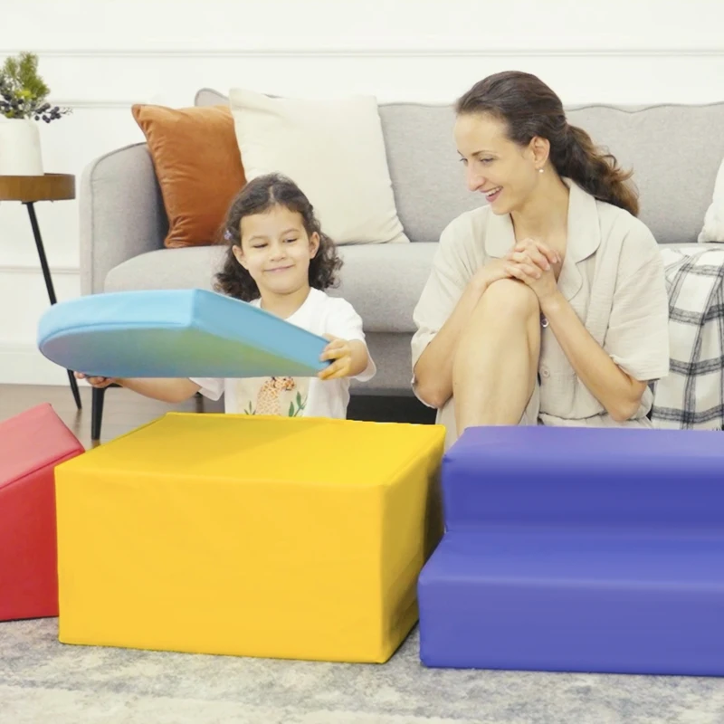 Child playing with modular foam blocks beside smiling parent