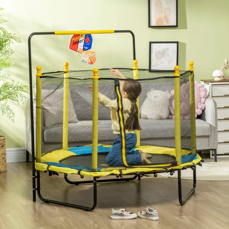 Child shooting basketball while playing on yellow indoor trampoline.
