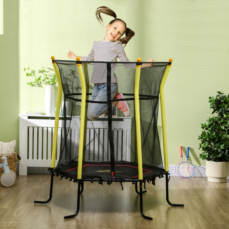 Young girl jumping joyfully on small trampoline with yellow poles.