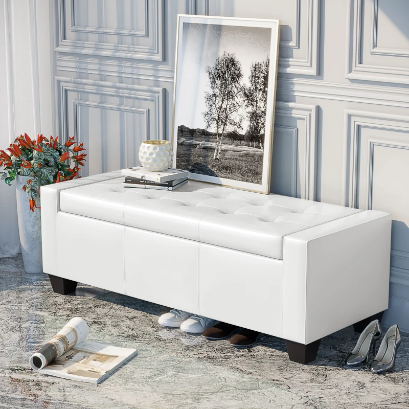 White leather tufted ottoman with framed art and decor in elegant hallway