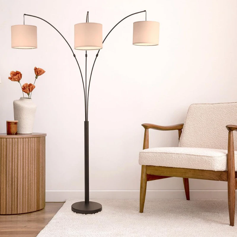 Three arm arc floor lamp with drum shades in living room