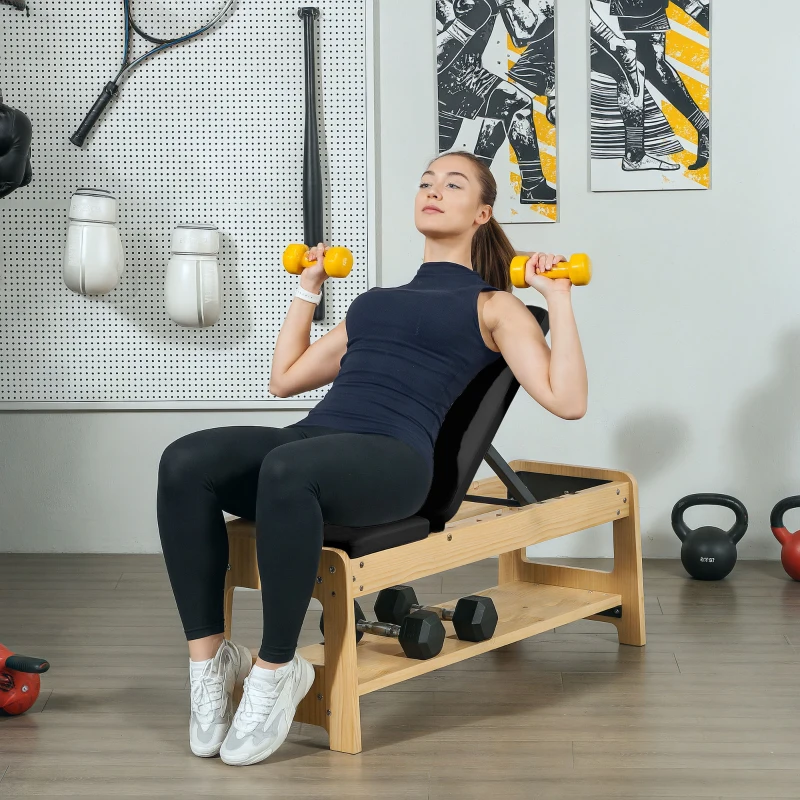 Woman lifting yellow dumbbells on wooden adjustable weight bench