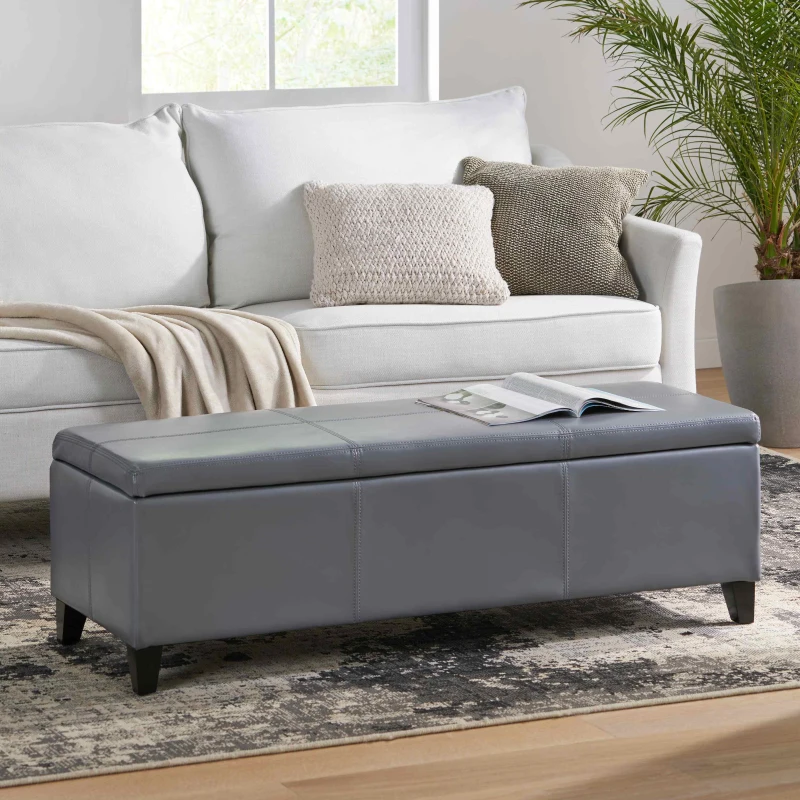 Gray faux leather ottoman bench in bright modern living room

