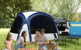 Family enjoying picnic beside blue camping tent and parked SUV