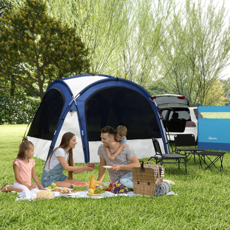 Family enjoying picnic beside blue camping tent and parked SUV