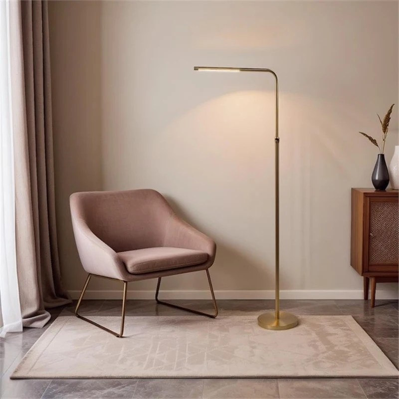 Slim gold floor lamp with LED light beside accent chair