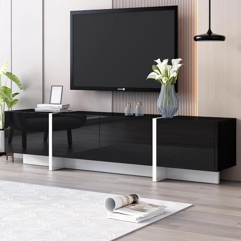 Modern black TV stand with decorative vase and books