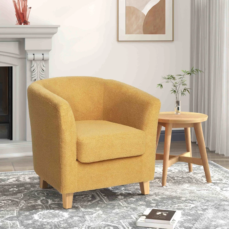 Vintage yellow tufted armchair with nailhead trim in cozy living room.