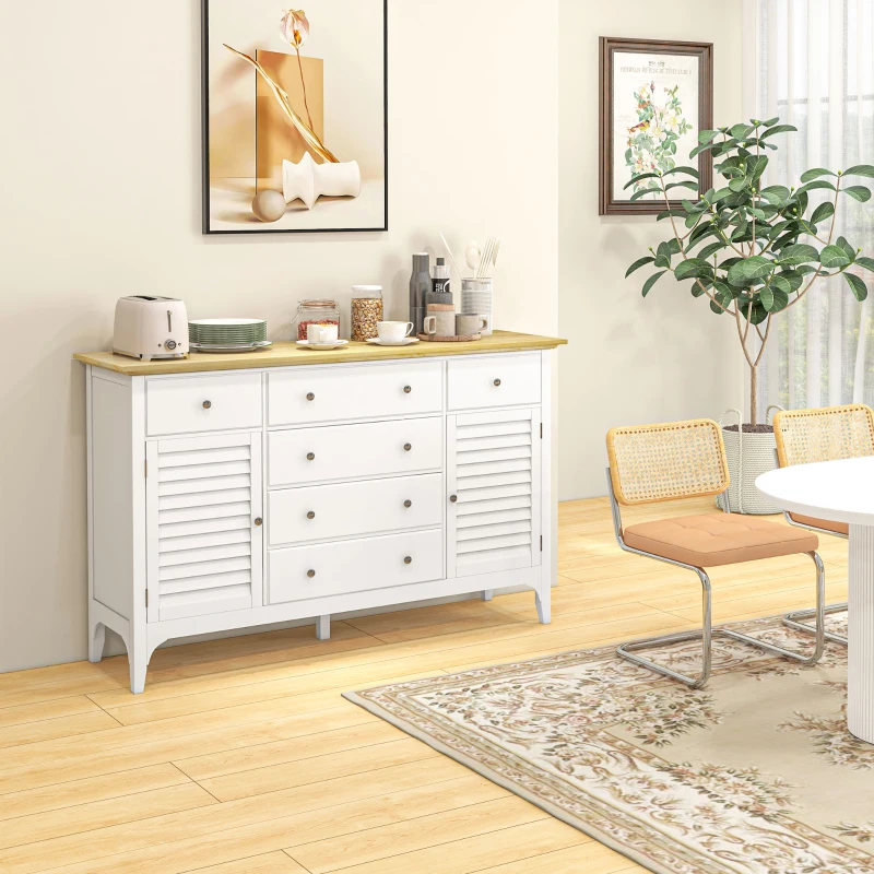 White sideboard with wooden top beside dining area and decor.
