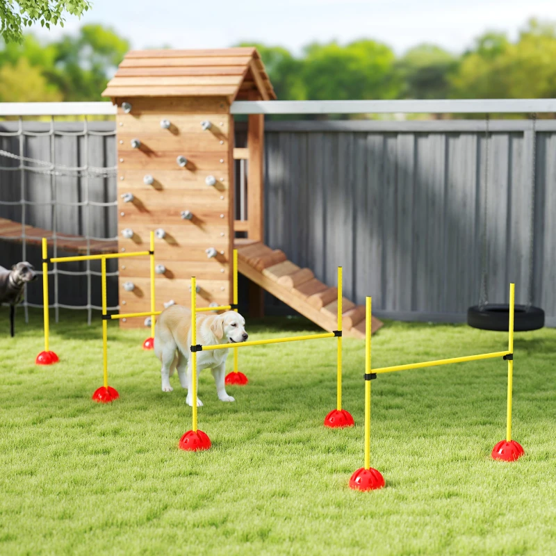 Dog practicing agility with yellow poles on green backyard grass.