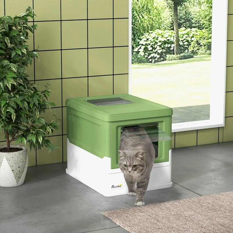 Grey cat exiting green and white litter box near window.
