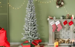 Festive living room with snow-flocked Christmas tree and gifts.