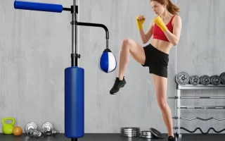 Woman practicing kickboxing with blue punching and reflex trainer.