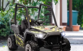 Camouflage ride-on off-road buggy parked on patio near garden.