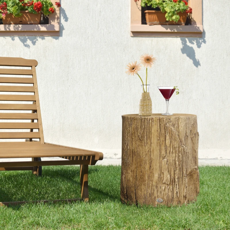 Outdoor wooden stump side table holding flowers and cocktail.