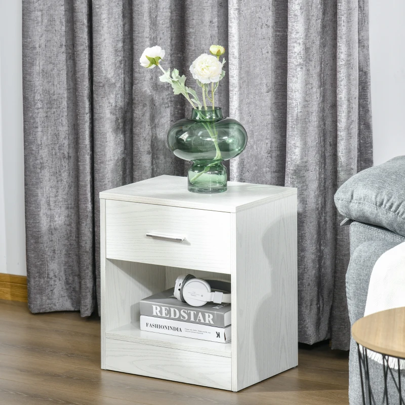 White wood side table with drawer and flower vase near curtain.
