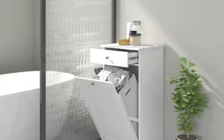 White bathroom laundry hamper with drawer open and clothes inside.