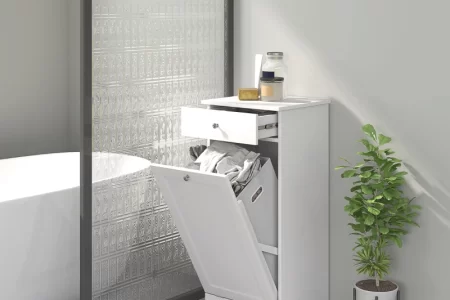 White bathroom laundry hamper with drawer open and clothes inside.