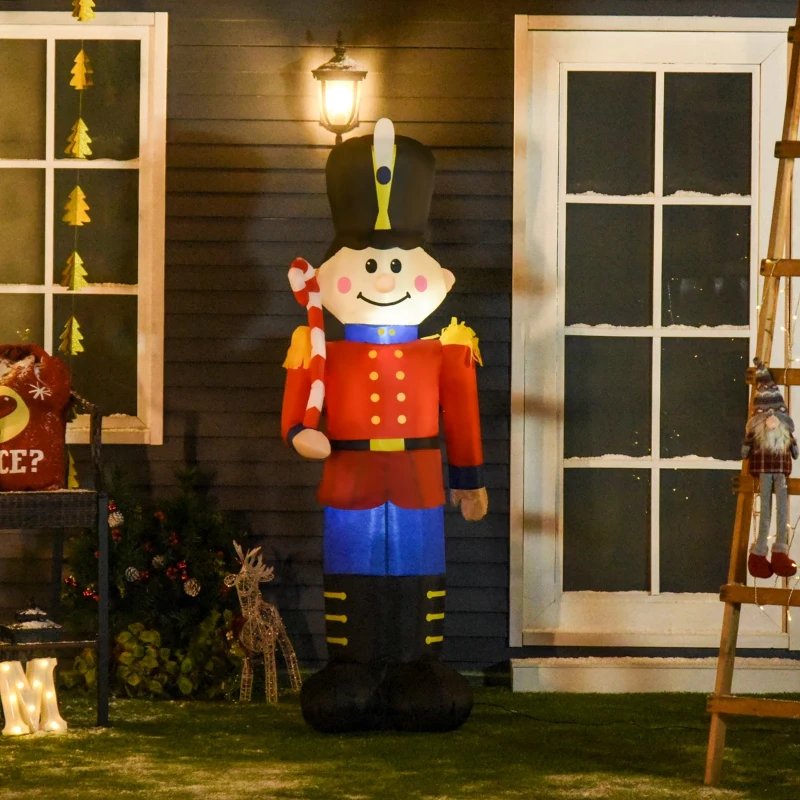 Large inflatable nutcracker holding candy cane outside festive house.