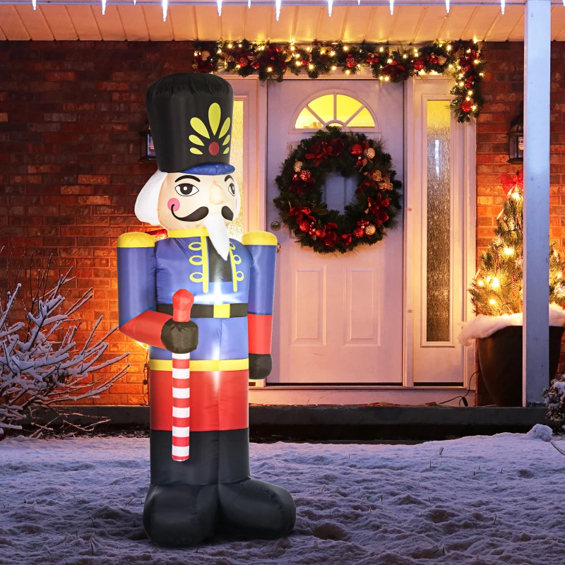 Inflatable nutcracker standing in front of decorated house with wreath.