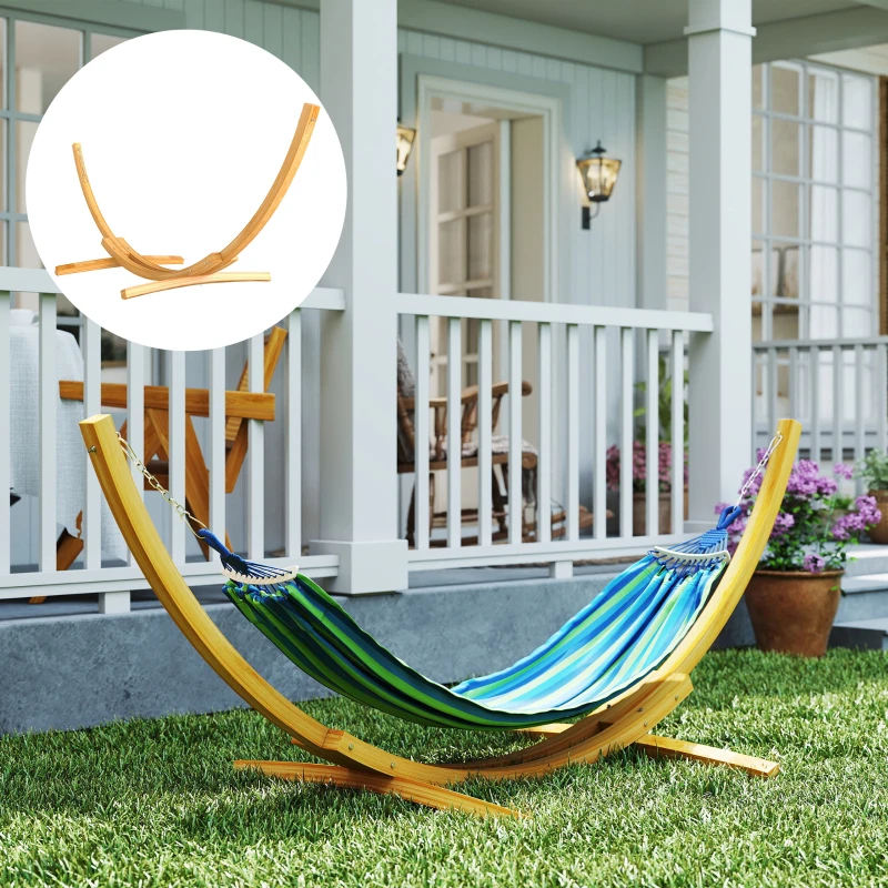 Wooden hammock stand on garden lawn near white porch.
