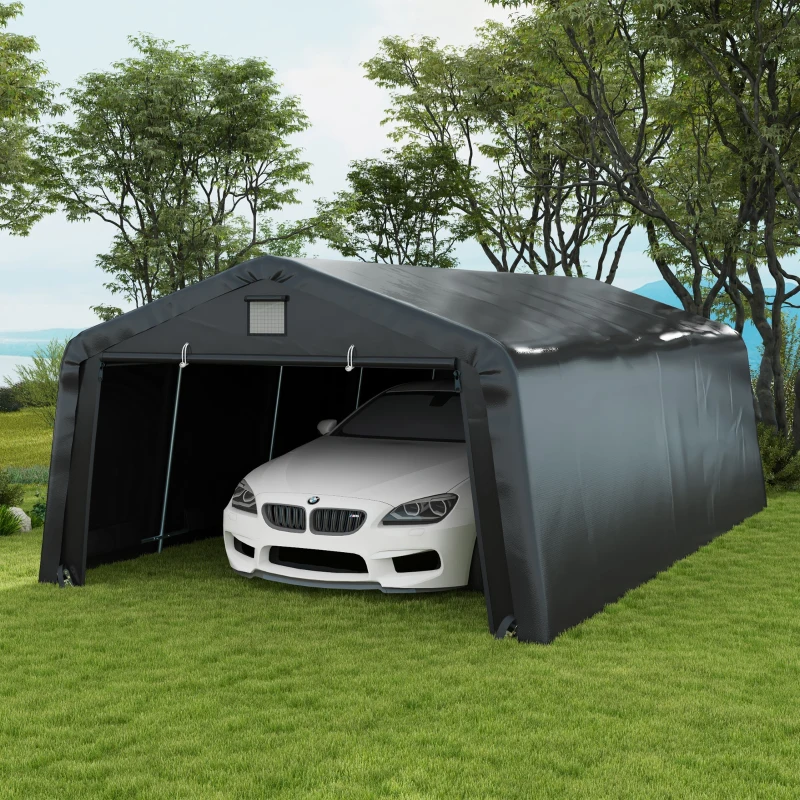 Black portable carport garage with white car parked inside on grass.
