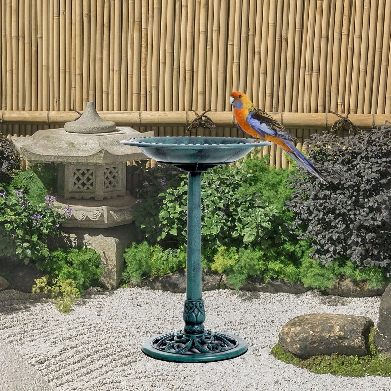 Resin bird bath with a fleur-de-lis pattern, ideal for outdoor bird watching.
